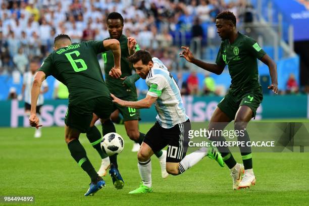 Argentina's forward Lionel Messi dribbles past Nigeria's defender Leon Balogun and Nigeria's midfielder Onyinye Ndidi during the Russia 2018 World...