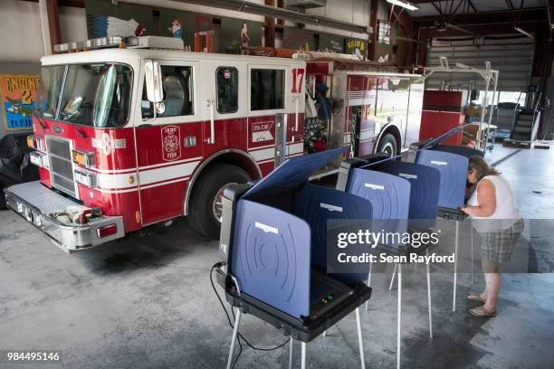 Woman casts a vote during a primary election at the North Lake fire station on June 26, 2018 in Irmo, South Carolina. The most notable race is a...