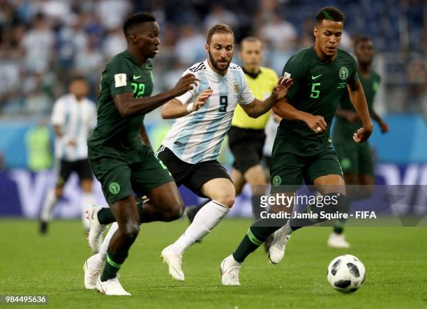 Gonzalo Higuain of Argentina is challend by Kenneth Omeruo and William Ekong of Nigeria during the 2018 FIFA World Cup Russia group D match between...