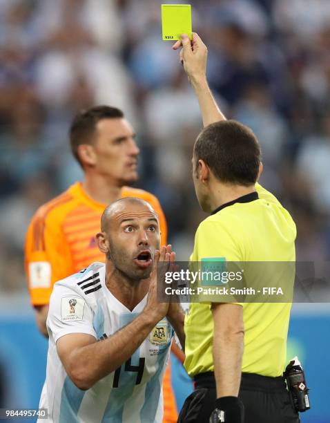 Referee Cuneyt Cakir gives a yellow racd to Javier Mascherano of argduring the 2018 FIFA World Cup Russia group D match between Nigeria and Argentina...