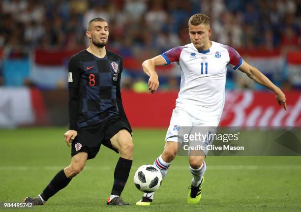 Alfred Finnbogason of Iceland passes the ball under pressure from Mateo Kovacic of Croatia during the 2018 FIFA World Cup Russia group D match...