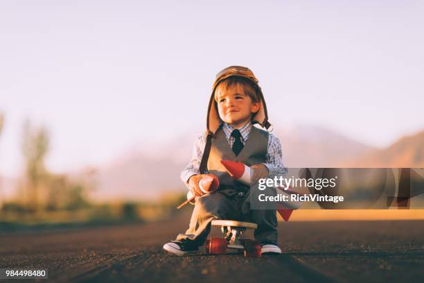 young business boy on skateboard with rockets - adult imitation stock pictures, royalty-free photos & images
