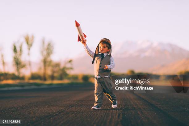 young boy business entrepreneur is flying a rocket - impact stock pictures, royalty-free photos & images