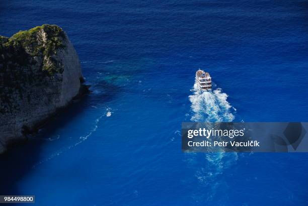 boat near navagio beach - navagio stock pictures, royalty-free photos & images