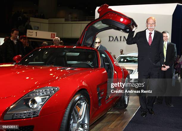 Dieter Zetsche, CEO of Daimler AG, poses at a Mercedes SLS car, at the company's annual shareholder's meeting at Messe Berlin on April 14, 2010 in...