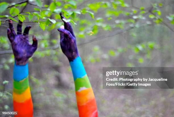 rainbow colored hands reaching for leaves - body paint stock pictures, royalty-free photos & images