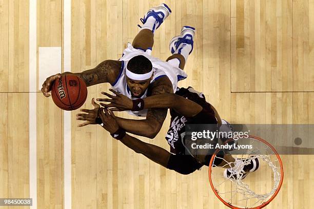 DeMarcus Cousins of the Kentucky Wildcats attempts a shot against Jarvis Varnado of the Mississippi State Bulldogs during the final of the SEC Men's...