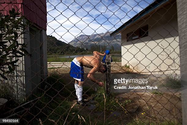 Soccer player for the team Azul Unido, cools off after a match against the O'Higgins on March 28, 2010 in Futaleufu, Chile. Soccer matches between...