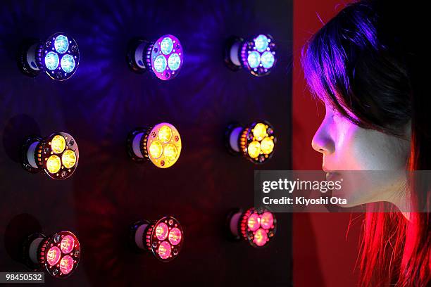 An exhibitor looks at LED Japan Corp.'s light emitting diode lightings, which effects health and beauty with specific wavelengths, during the second...