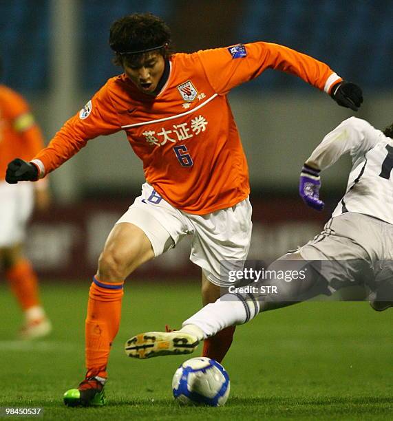 Zhou Haibin of China's Shandong Luneng fights for the ball with Tkayanagi Issei of Japan's Sanfrecce Hiroshima during the AFC Champions League match...