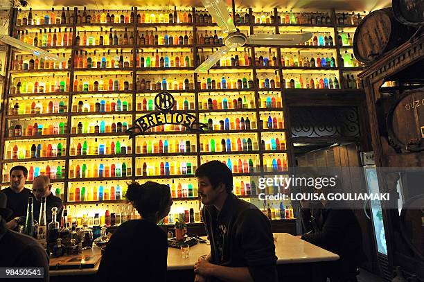 Couple sits in a bar in central Athens Plaka district on April 8, 2010. AFP PHOTO/ LOUISA GOULIAMAKI