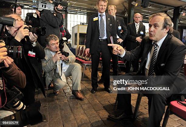 President Michel Platini jokes with photographers prior to the UEFA Europa League Final 2010 Cup Handover ceremony in Hamburg April 13, 2010. The...