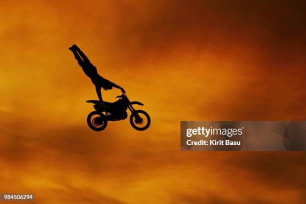 the silhouette of a person jumping with a dirt bike. - images stock pictures, royalty-free photos & images