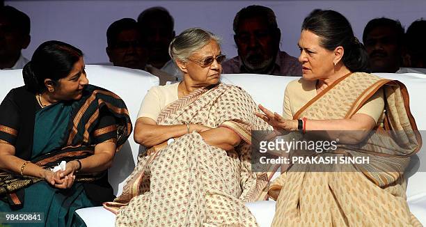 United Progressive Alliance Chairperson Sonia Gandhi gestures while talking with Bhartiya Janta Party leader and Member of Opposition Sushma Swaraj...
