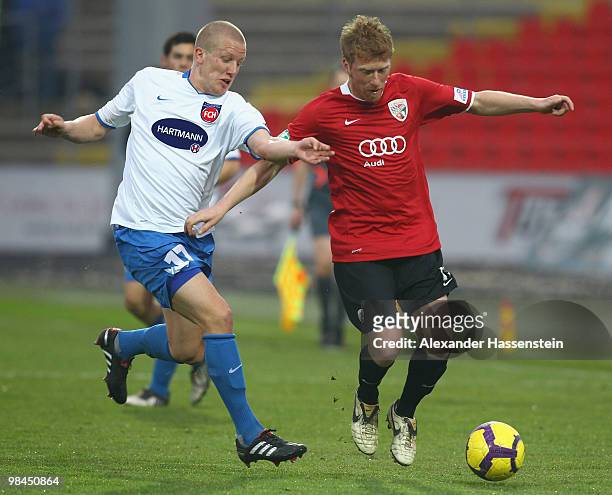 Andreas Neuendorf of Ingolstadt battles for the ball with Richard Weil of Heidenheim during the 3.Liga match between FC Ingolstadt and 1. FC...