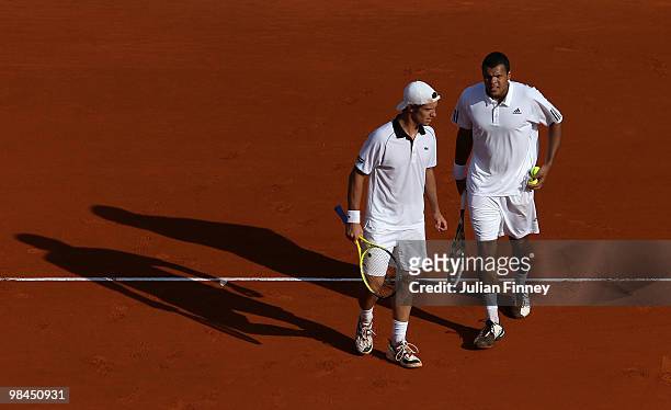 Jo-Wilfried Tsonga of France and Richard Gasquet of France talk tactics in their doubles match against Marcel Granollers and Tommy Robredo of Spain...
