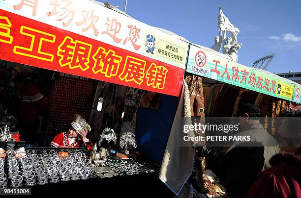 People shop at an outdoor market in Beijing on April 13, 2010. The Asian Development Bank urged China to step up efforts to boost domestic...