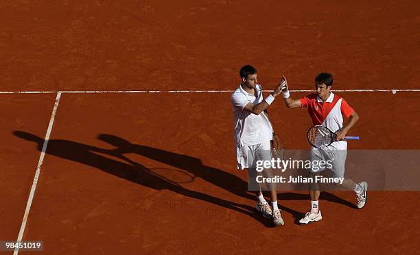 Marcel Granollers and Tommy Robredo of Spain support each other in their doubles match against Jo-Wilfried Tsonga of France and Richard Gasquet of...