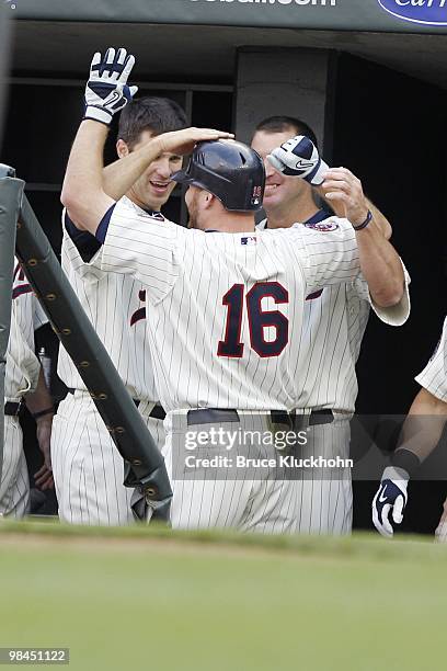 April 12: Jason Kubel of the Minnesota Twins celebrates the first home run ever at Target Field against the Boston Red Sox with Joe Mauer on April...