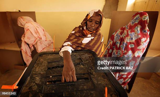 Sudanese woman casts her vote at a polling station in the village of Umm Dawban, 40 kms north of Khartoum, on April 13, 2010. Sudanese trickled into...