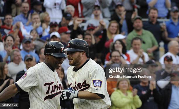 Delmon Young and Jason Kubel of the Minnesota Twins celebrate after Kubel hit the first home run at Target Field in the seventh inning against the...