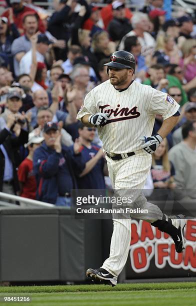 Jason Kubel of the Minnesota Twins runs home after hitting the first home run at Target Field in the seventh inning against the Boston Red Sox during...