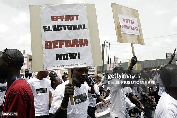 Dozens of youths carry placards during a march through Lagos streets to government house to protest the lull in the economy and government...