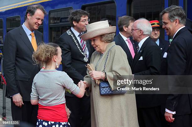 Queen Beatrix from The Netherlands is welcomed by 2 Dutch girls during her visit at Railway Museum on April 14, 2010 in Utrecht, Netherlands.