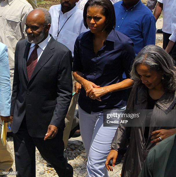 First Lady Michelle Obama speaks with Haitian Prime Minister Rene Preval and his wife Elisabeth Delatour Preval during a surprise visit to Haiti on...