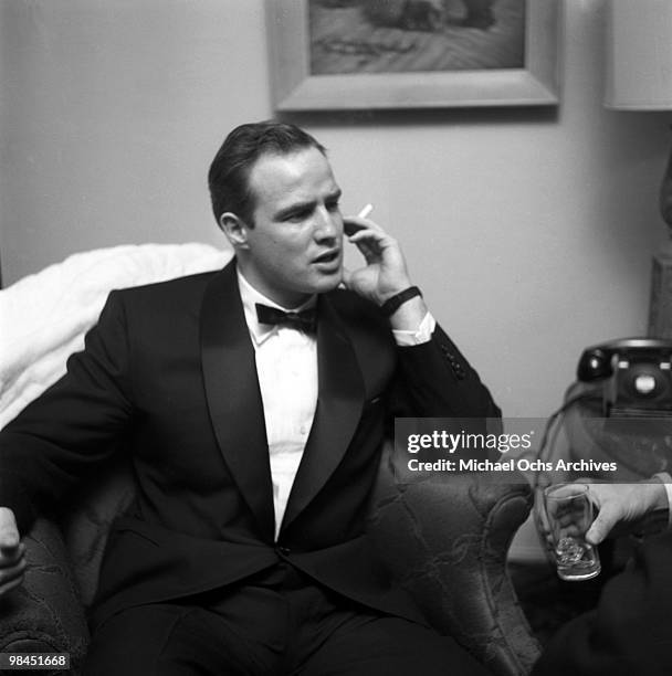 Actor Marlon Brando smokes a cigarette as he attends a party on February 24, 1955 in Los Angeles, California.
