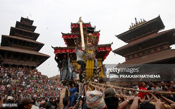 Nepalese Hindu devotees pull a wooden chariot as they take part in Bisket Jatra, a festival held in celebration of the Nepalese New Year in...