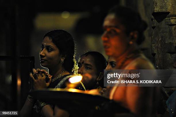 Sri Lankan women offer prayers at a Hindu Temple in celebration of the traditional Sinhala and Tamil New Year in Colombo on April 14, 2010. The new...