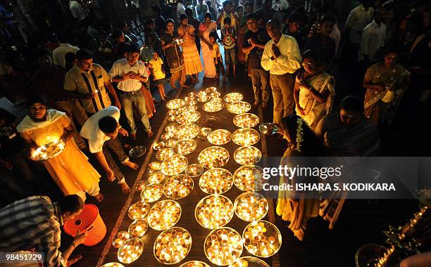 Sri Lankan women devotees offer prayers at a Hindu Temple in celebration of the traditional Sinhala and Tamil New Year in Colombo on April 14, 2010....