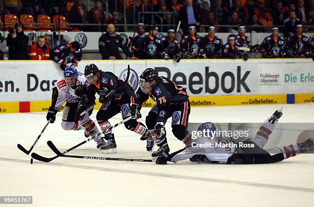 Benedikt Kohl of Augsburg tries to stop Andreas Morczinietz of Wolfsburg during the third DEL play off semi final match between Grizzly Adams...