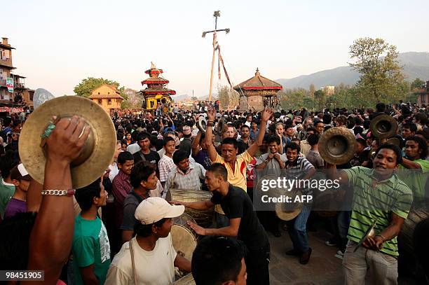 Nepalese people dance to a drum as they take part in Bisket Jatra, a festival held in celebration of the Nepali New Year in Bhaktapur, some 12kms...
