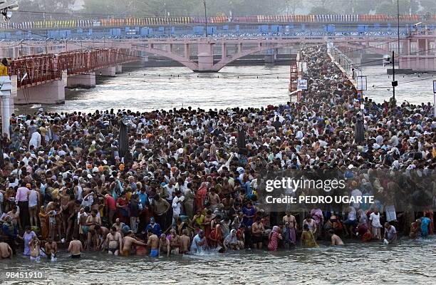 Hindu devotees arrive at the river Ganges to take a bath during the Kumbh Mela festival in Haridwar on April 14, 2010. The Kumbh Mela, world's...