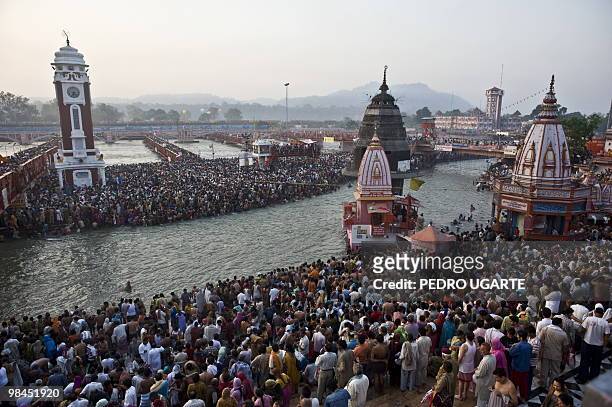 Hindu devotees arrive at the river Ganges to take a bath during the Kumbh Mela festival in Haridwar on April 14, 2010. The Kumbh Mela, world's...