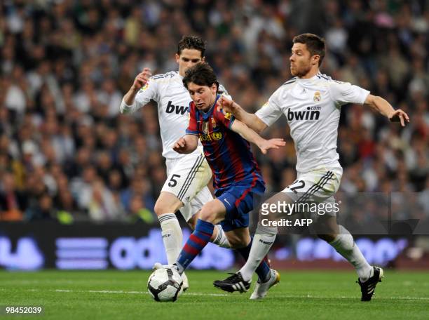 Barcelona's Argentinian forward Lionel Messi vies for the ball with Real Madrid's midfielder Xabi Alonso during the 'El Clasico' Spanish League...