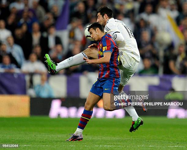 Real Madrid's defender Alvaro Arbeloa vies with Barcelona's midfielder Sergio Busquets during the 'El Clasico' Spanish League football match Real...
