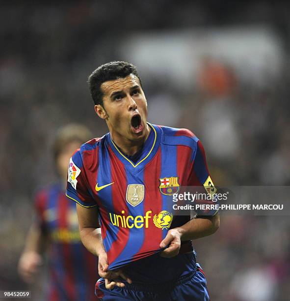 Barcelona's forward Pedro Rodriguez celebrates after scoring during the 'El Clasico' Spanish League football match Real Madrid against Barcelona at...