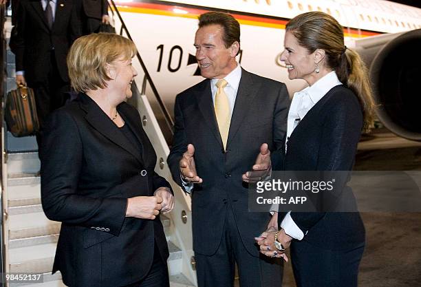 This photo made available by the German government press office shows California Governor Arnold Schwarzenegger and his wife Maria Shriver greeting...