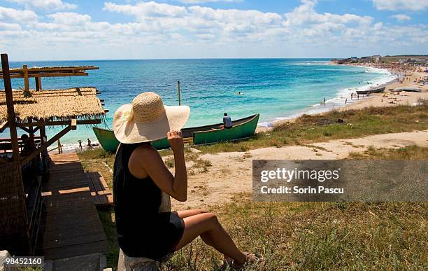woman sitting on the hut beach - constanta stock pictures, royalty-free photos & images