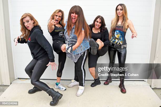 Courtney Cox, Linda McDonald, Kirsten Rosenberg, Wanda Ortiz, and Nikki Stringfield of the rock band The Iron Maidens pose backstage at BMI Indoor...