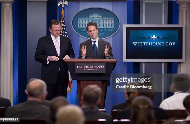 Timothy Geithner, U.S. Treasury secretary, right, speaks in the James Brady briefing room at the White House with Robert Gibbs, White House press...