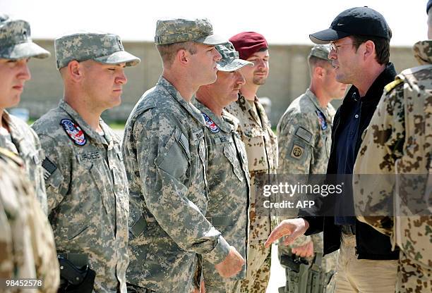 German Defence Minister Karl-Theodor zu Guttenberg greets US army soldiers who flew out injured and dead comrades on April 14, 2010 in Kunduz,...
