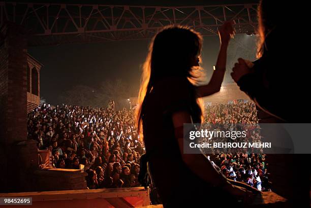 Entertainment-music-Pakistan-unrest,FEATURE by Hasan Mansoor woman dances as as other students enjoy the performance of the band "Overload" during a...