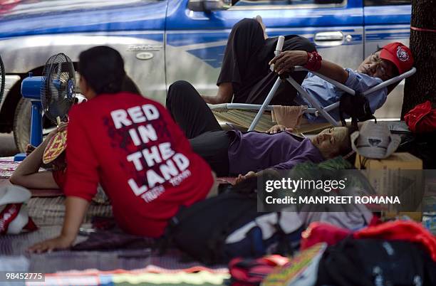 "Red Shirt" anti-government protesters rest at the site of their ongoing rally at the Democracy Monument in central Bangkok on April 14, 2010....