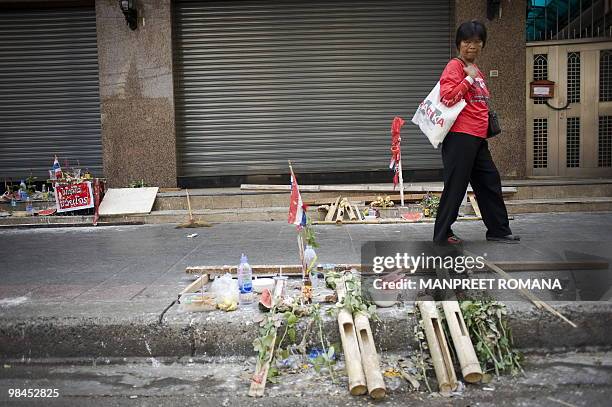 Red Shirt" anti-government protester walks by the site of recent deadly clashes near the Democracy Monument as the group's rally continues in central...
