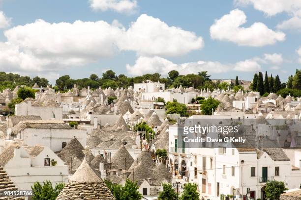 view over the trulli houses alberobello, puglia, italy - conical roof stock pictures, royalty-free photos & images