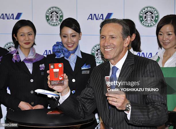 Starbucks chairman and CEO Howard Schultz displays the company's new instant coffee "VIA" during a launching ceremony at Tokyo's Haneda airport on...